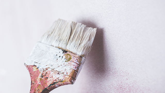 paint brush painting a white wall